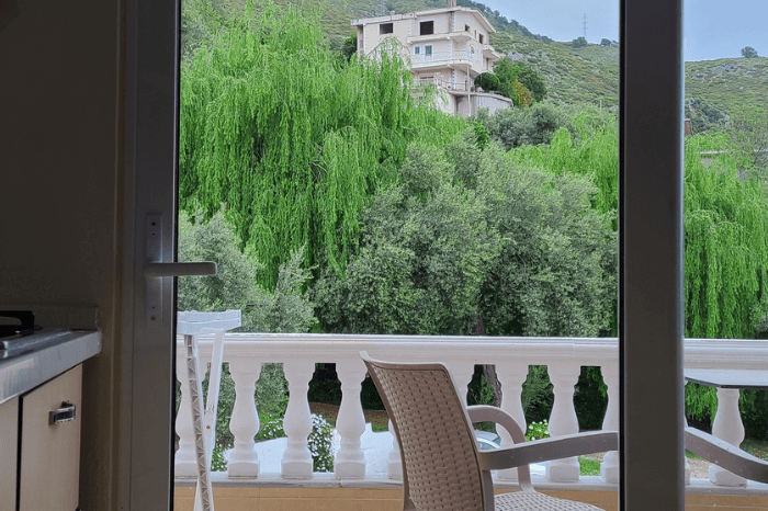 A look out the patio doors from a garden view room in Onirana apartments