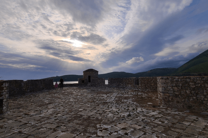 Porto Palermo castle from the roof with beautiful clouds and the sun peeking through.