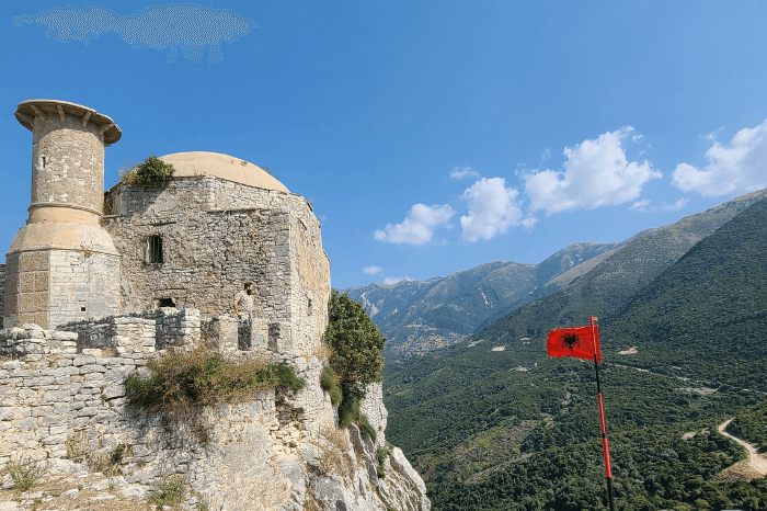 The castle of Borsh with an Albanian flag, high in the mountains