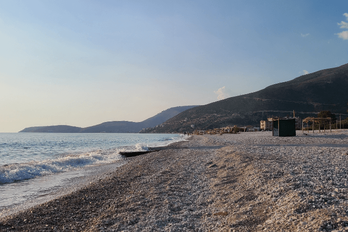 Plazhi i Borshit (beach of Borsh) close to sunset with the hills in the background