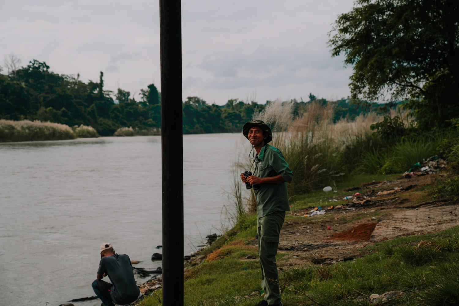 Local Tharu guide watching for wildlife on the banks of the Narayani River in Chitwan National Park.