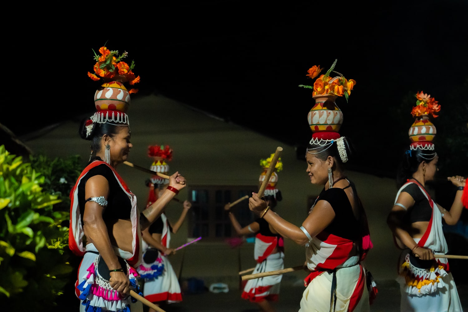 Tharu women wearing traditional dress dancing.