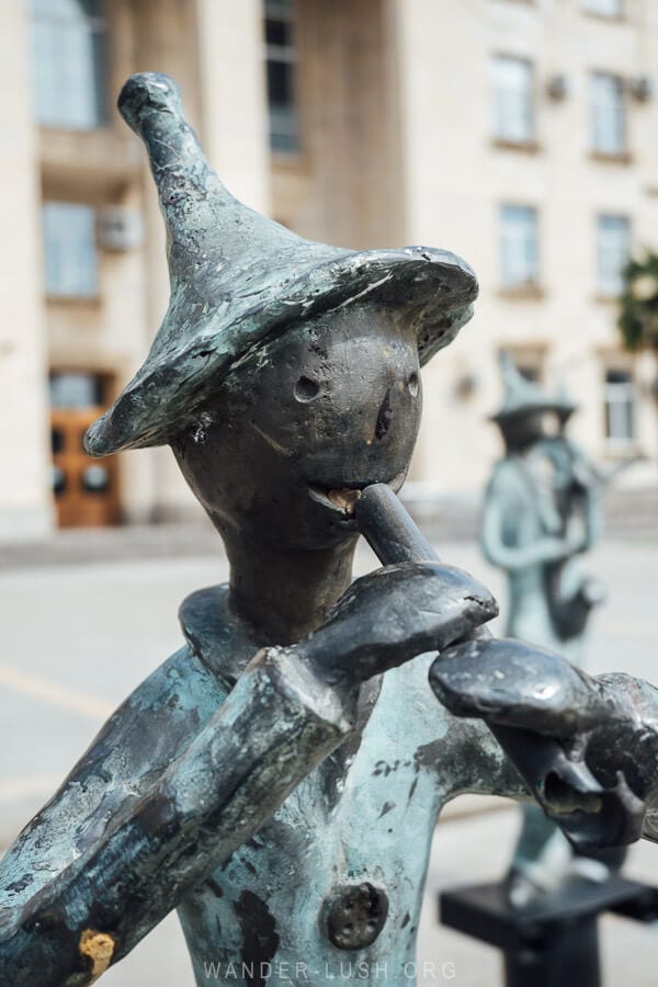 Close up of a bronze flute player sculpture in Rustavi, Georgia.