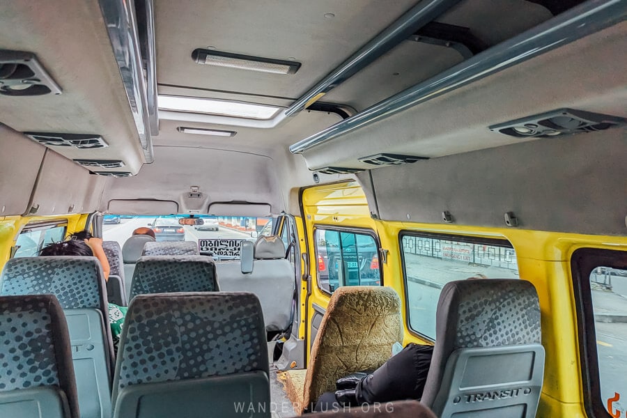 Passengers seated inside a yellow marshrutka van travelling from Tbilisi to Rustavi in Georgia.