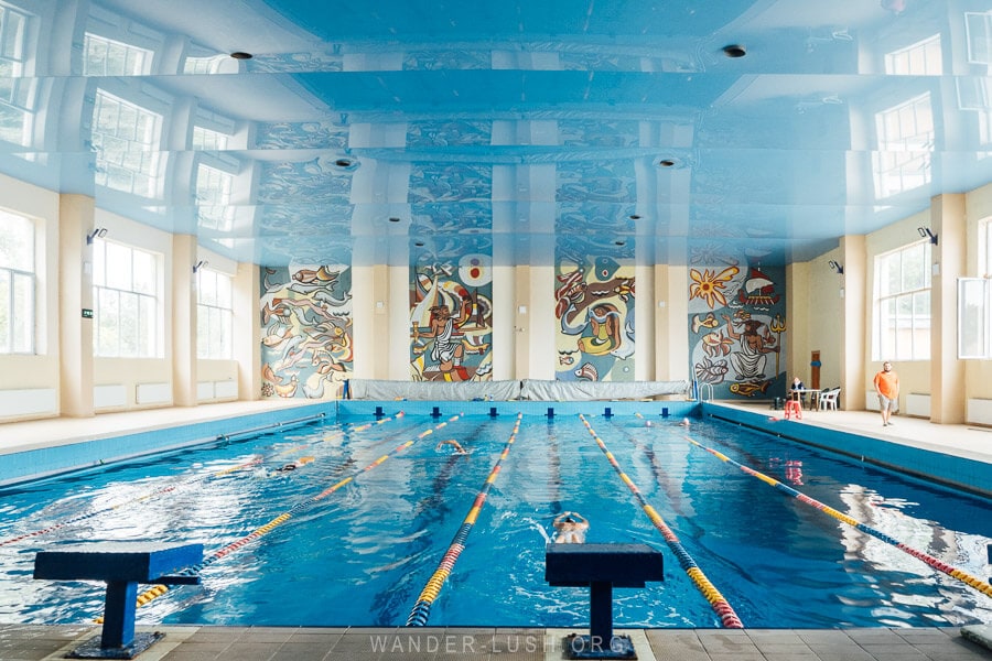 An indoor swimming pool in Rustavi, Georgia decorated with four colourful Soviet mosaic panels that reference different myths and legends.