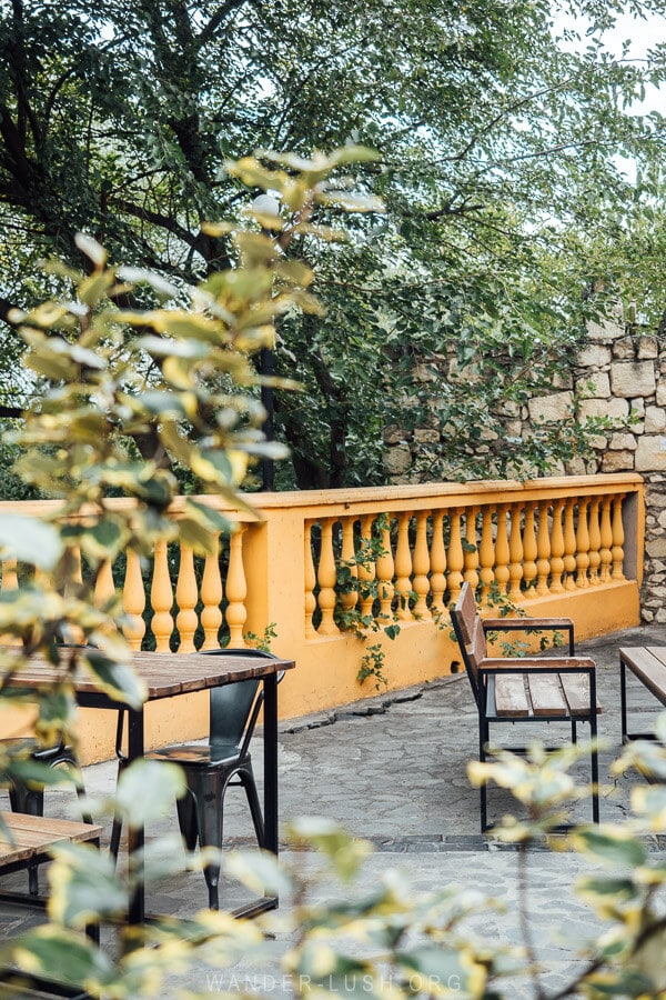 A restaurant in Rustavi Georgia with tables set on an outdoor terrace.