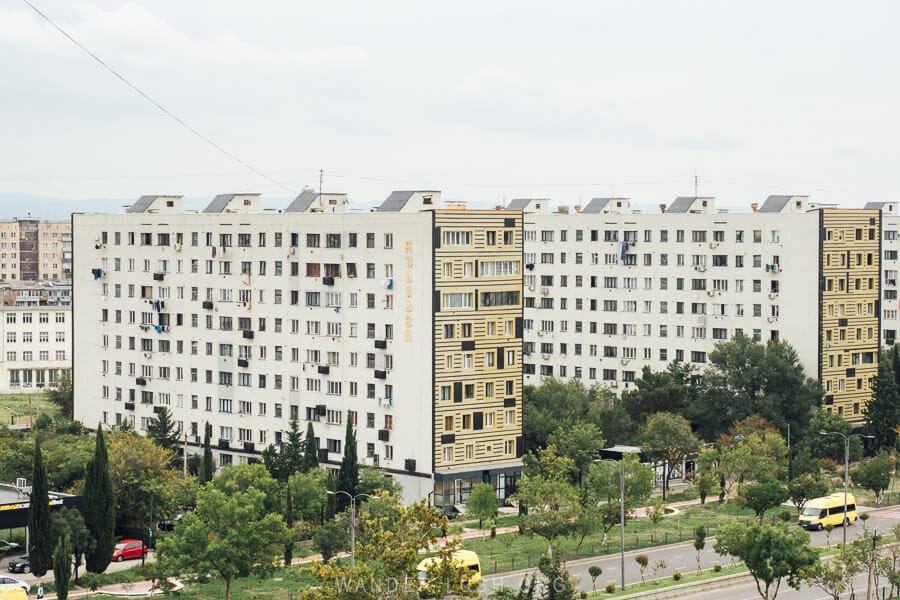 Uniform apartment buildings with new yellow and white facades in Rustavi, Georgia.