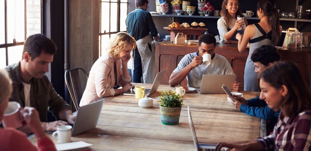 Coffee shop with customers using a laptop device. 