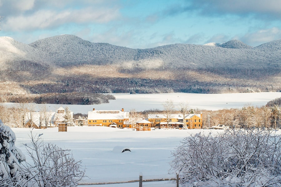 Cute buildings set under a snow-dusted hill at the Mountain Top Resort in Vermont.