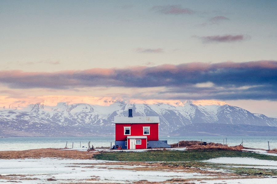 A red cabin beneath a winter sky in Iceland.