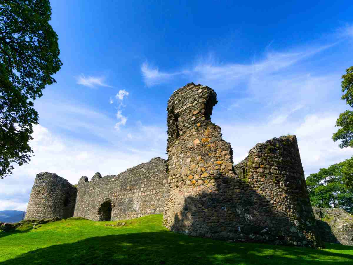 Old Inverlochy Castle on a sunny day with blue skies and cotton clouds