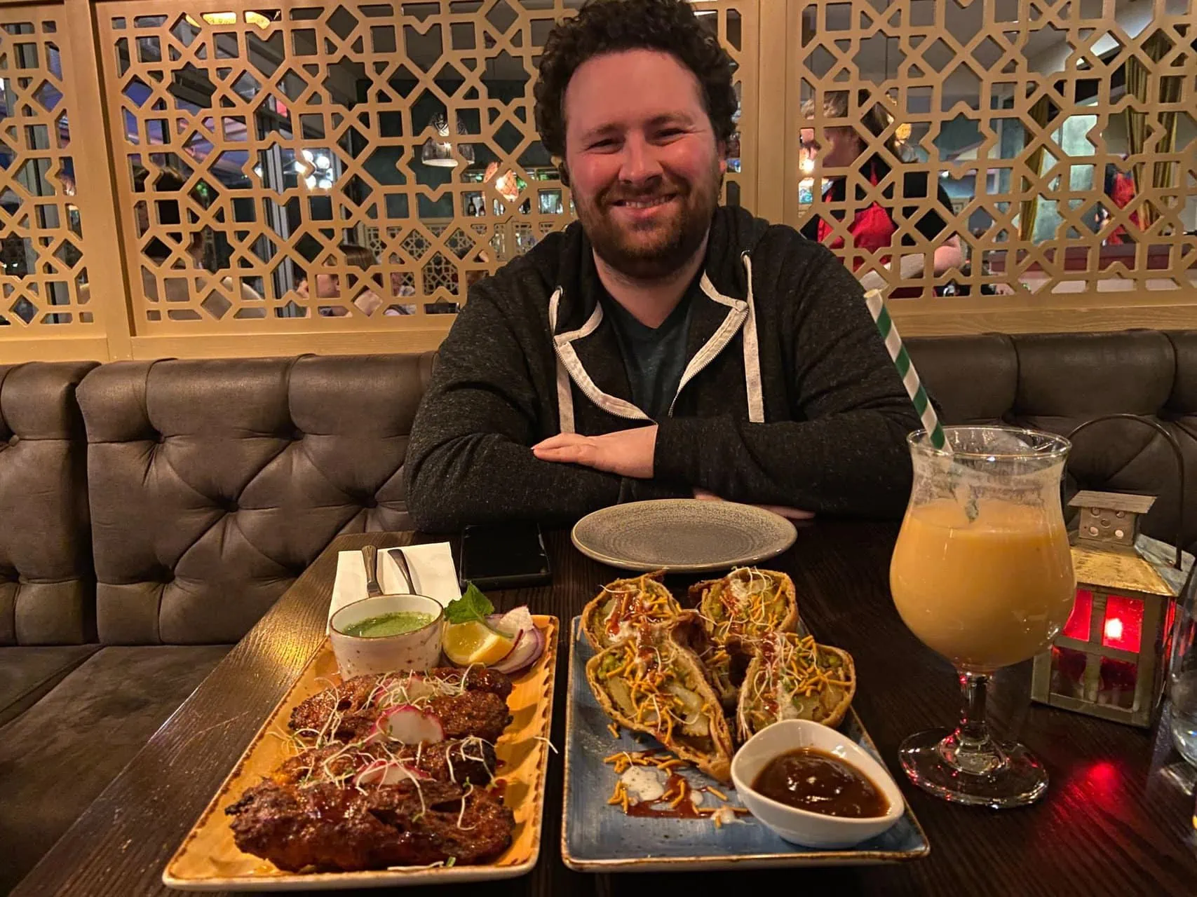 Colin smiling in front of our dinner at Bombay Palace Wanaka