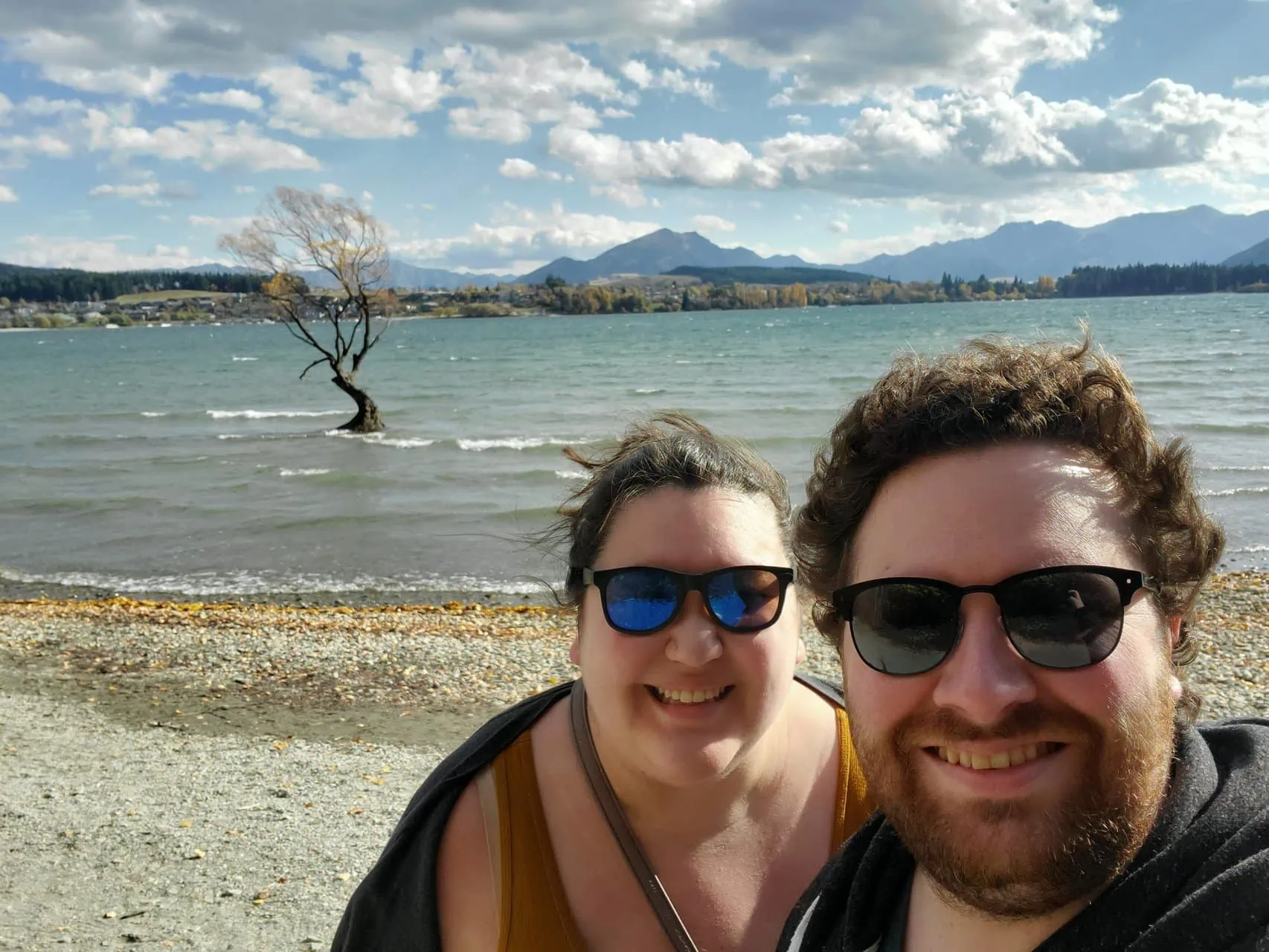 Colin and Riana selfie in front of #ThatWanakaTree, sharing things to do in Wanaka