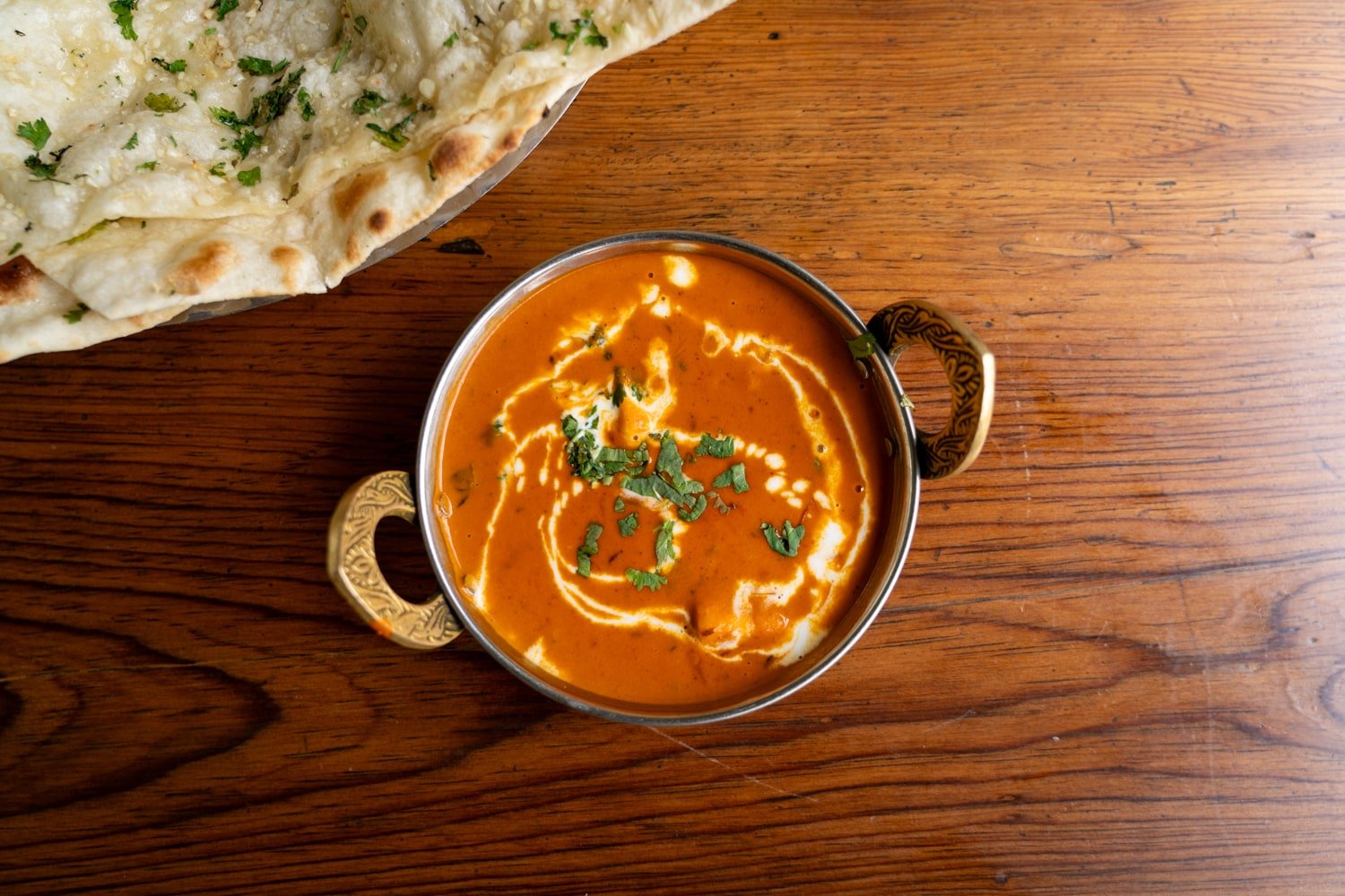 A decorative dish with butter paneer masala sat on the table.