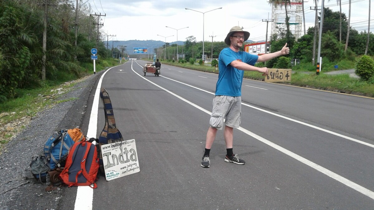 Hitchhiking by the side of the road in Thailand