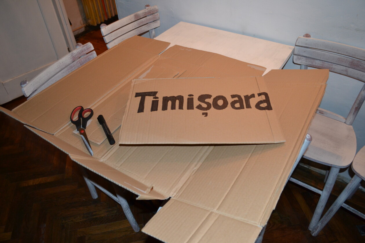 Making a hitchhiking sign for Timisoara in Romania