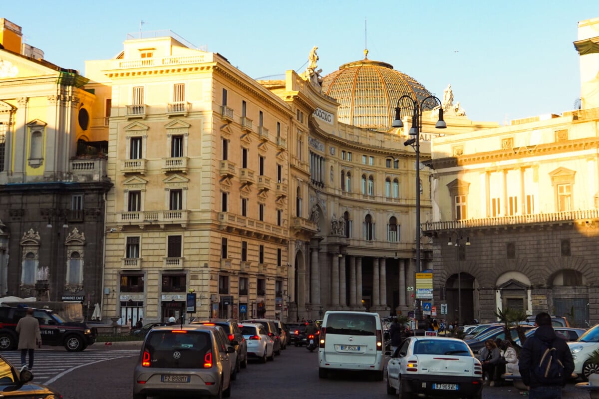 The bustling city street in Naples, Italy, showcasing the vibrant urban energy and rich architectural heritage.