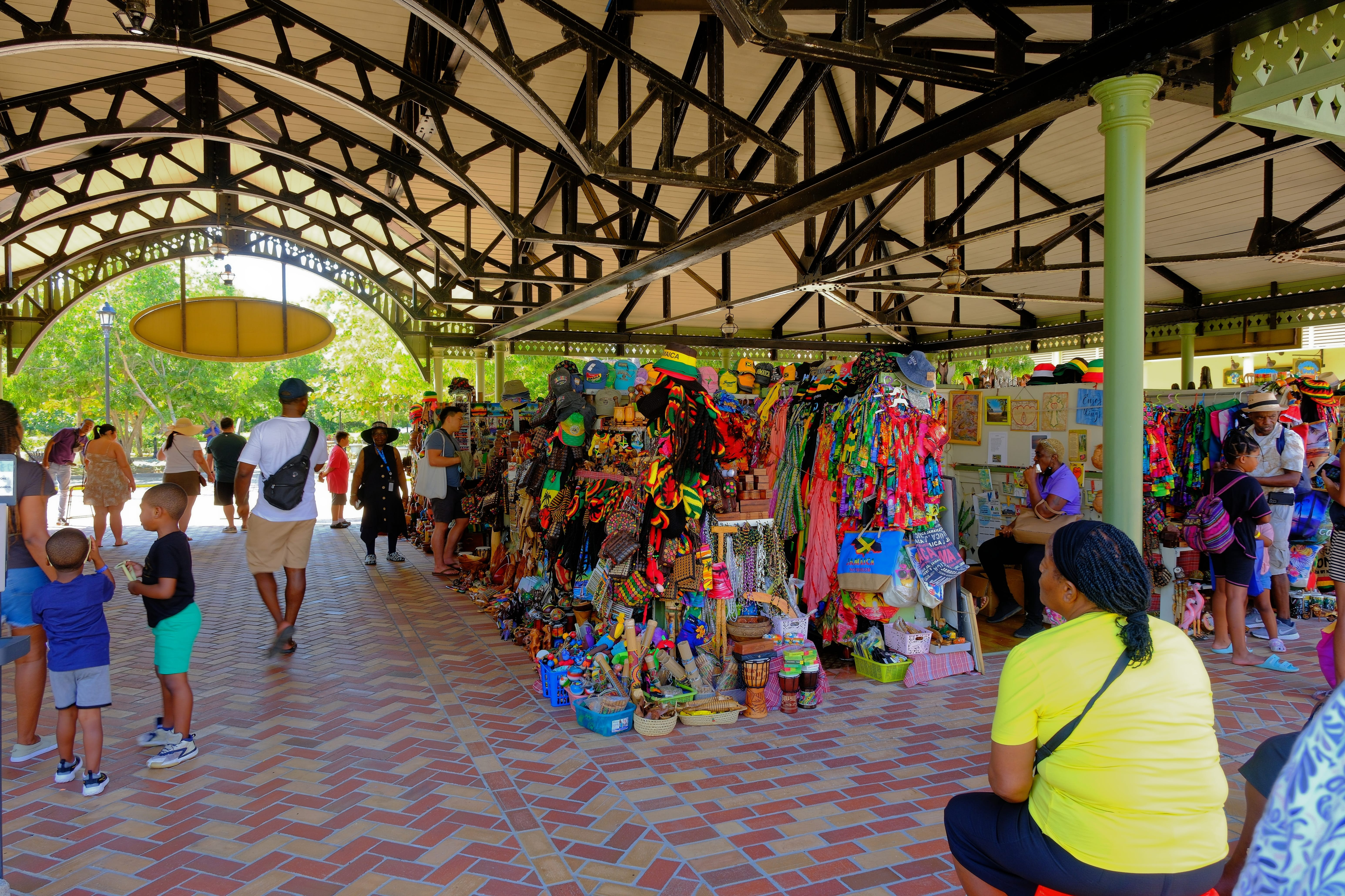 Tourists and vendors at an outdoor crafts market in Falmouth, Jamaica