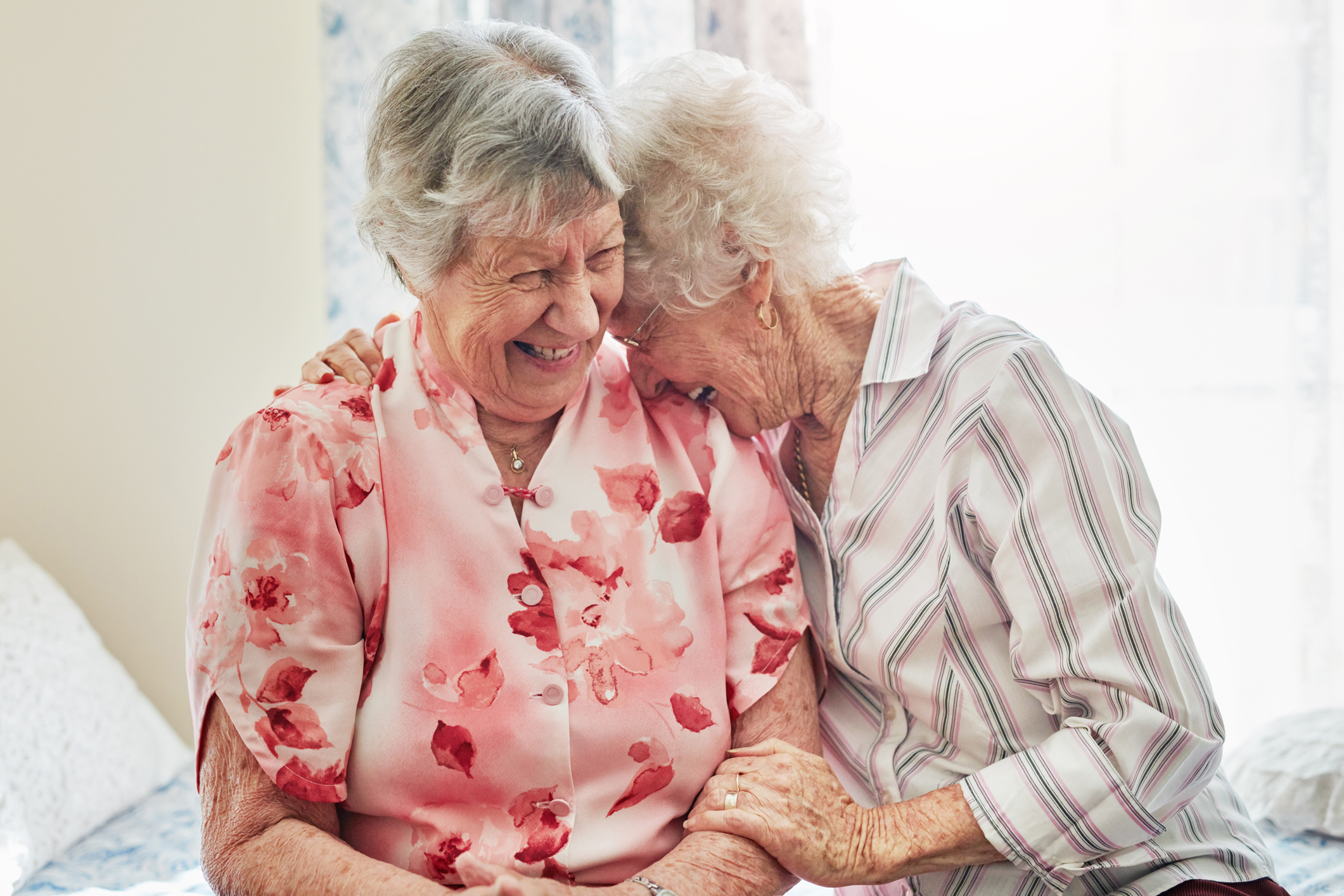 Two people holding each other and laughing.