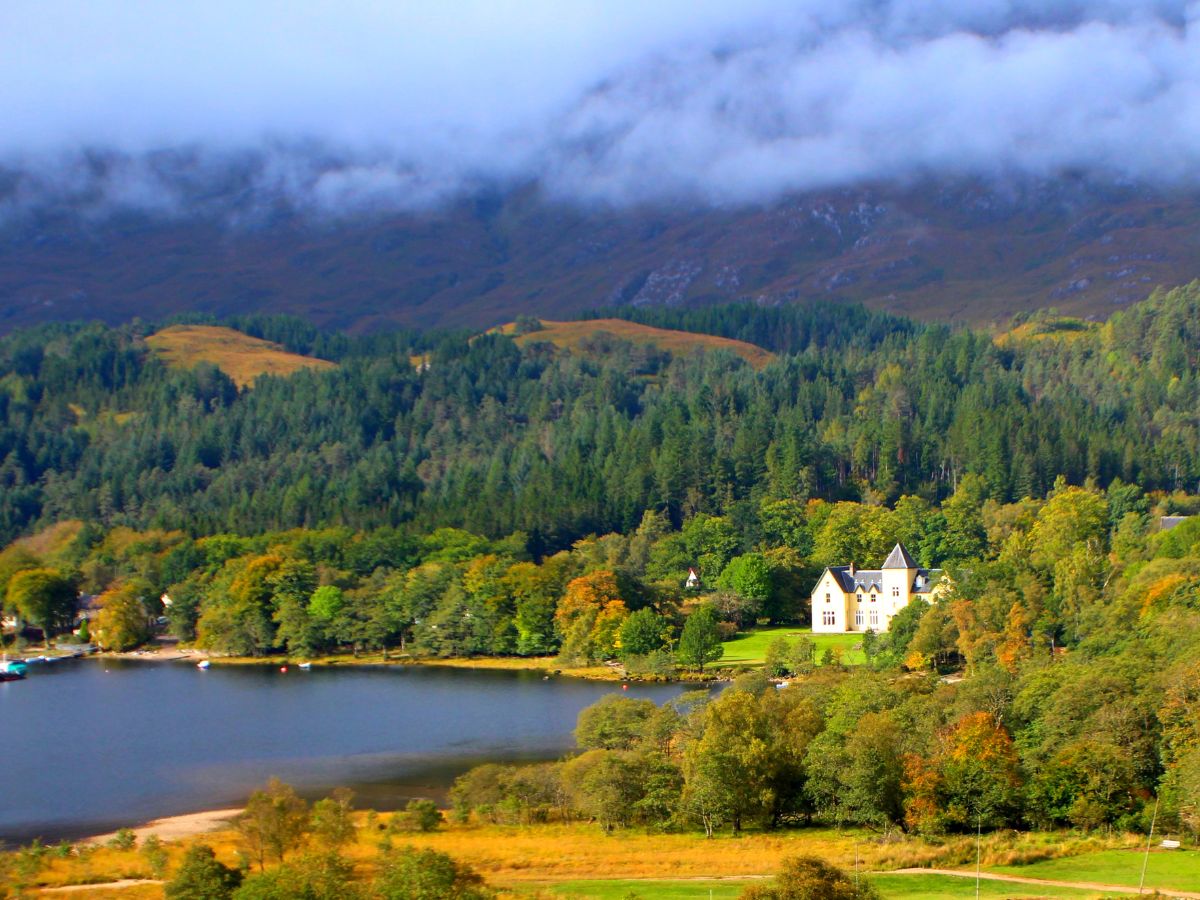 Landscape around Loch Shiel with a view of Glenfinnan House Hotel in the distance on the right.