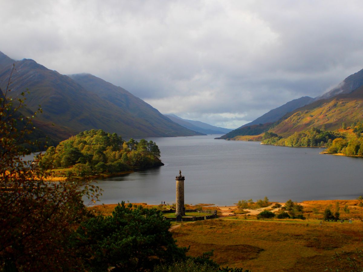 view of Loch Shiel and Glenfinnan Monument surrounded by mountains on the Road to the Isles