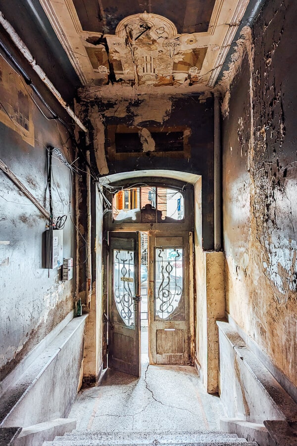 An historic entryway in Tbilisi with flaking paint.