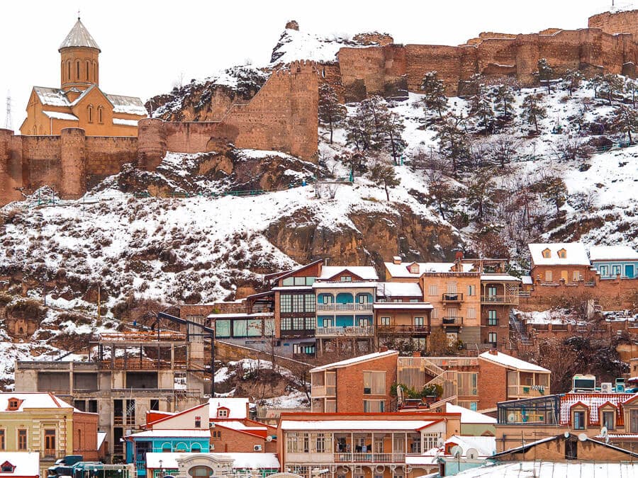 Winter in Tbilisi Old Town, with Narikala Fortress dusted in snow.