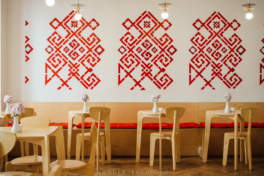 A modern cafe with red stencils on the wall.