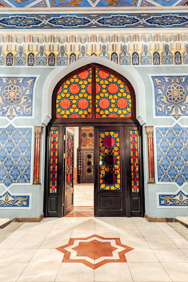 Foyer of the Tbilisi State Opera and Ballet Theatre on Rustaveli Avenue, with painted walls and stained glass.