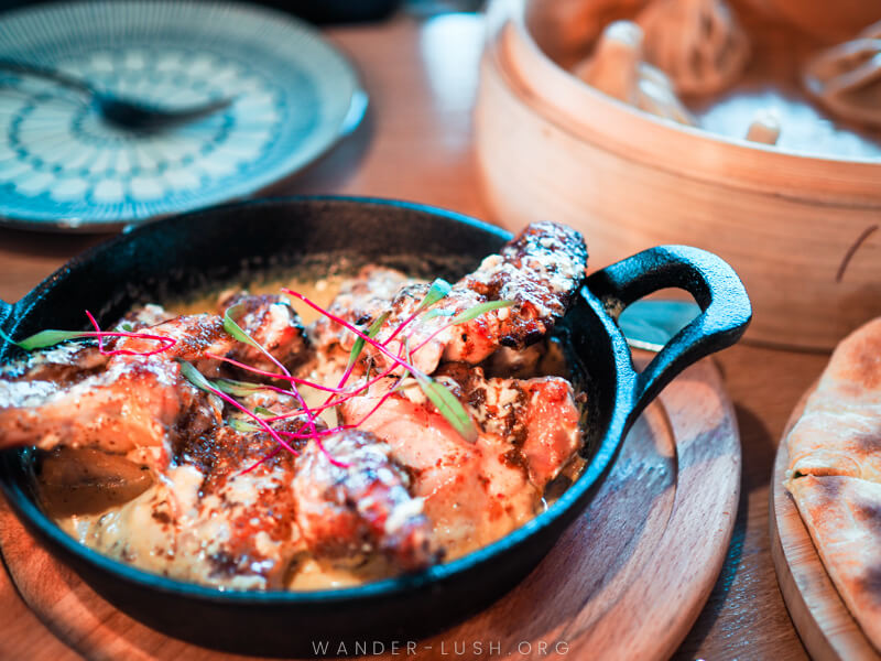 A pan of chicken coated with garlic sauce.