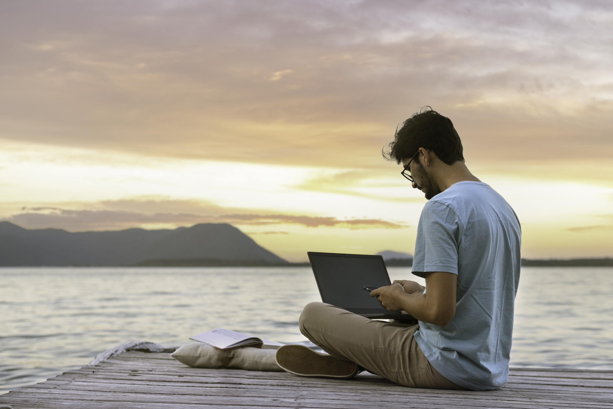 digital nomad working on pier