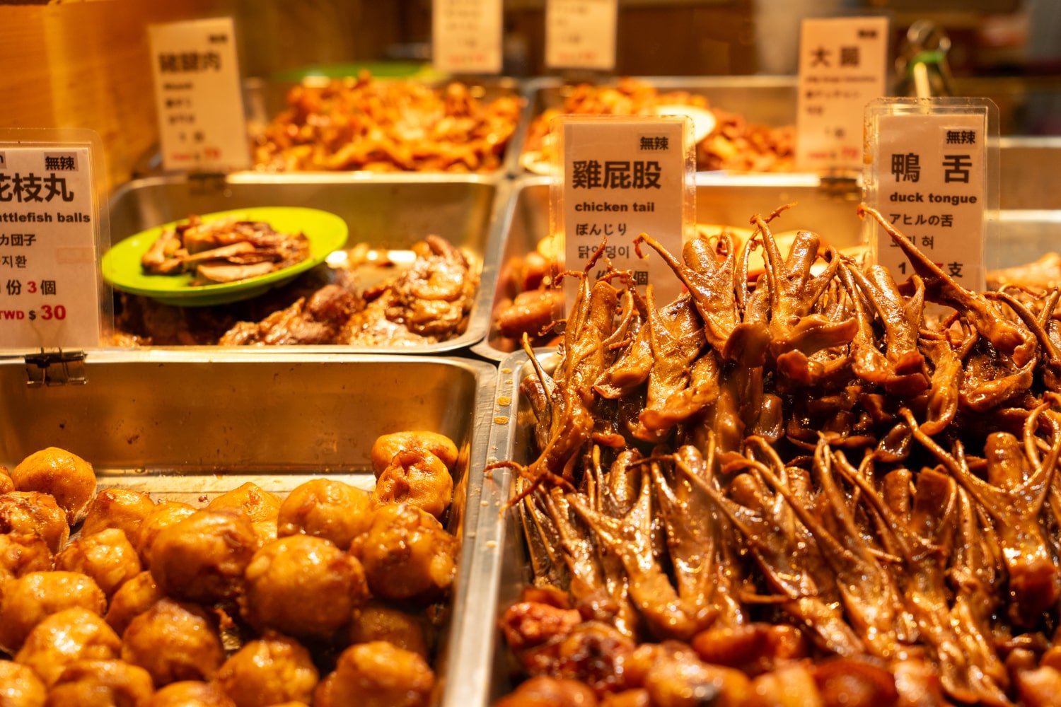 Street food meat on display in platters on Jiufen Old Street.