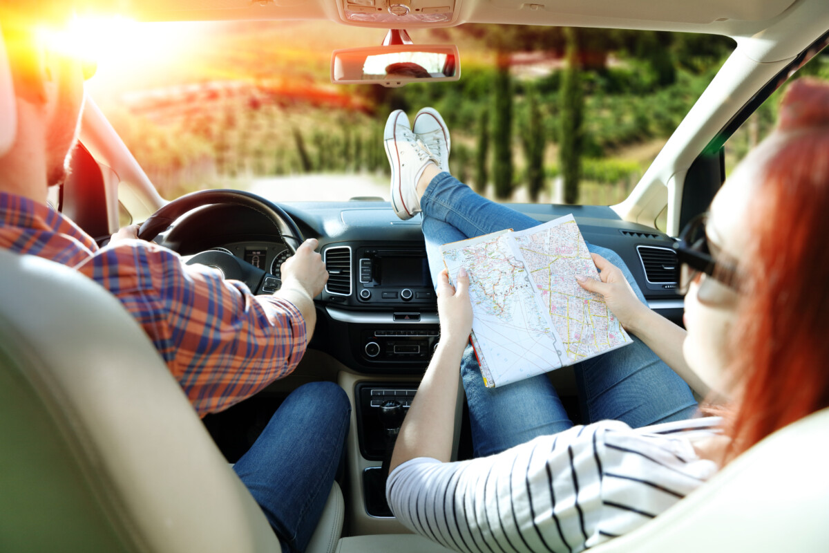 couple in car with a map on a road trip