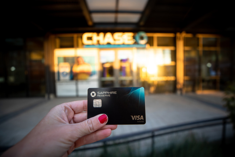 Holding the Chase Sapphire Reserve Card in front of Chase Bank