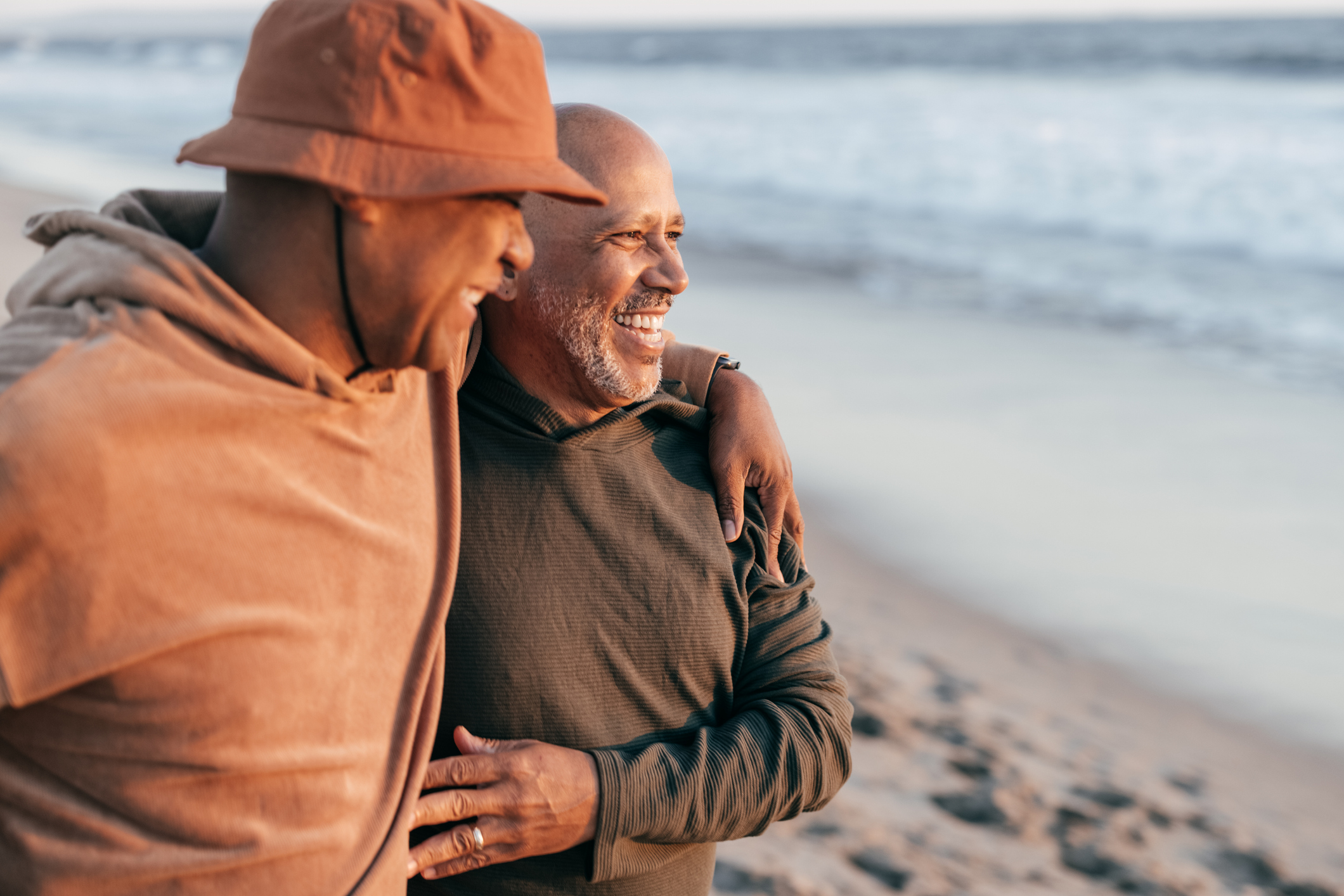 Two people looking happy together on a beach.