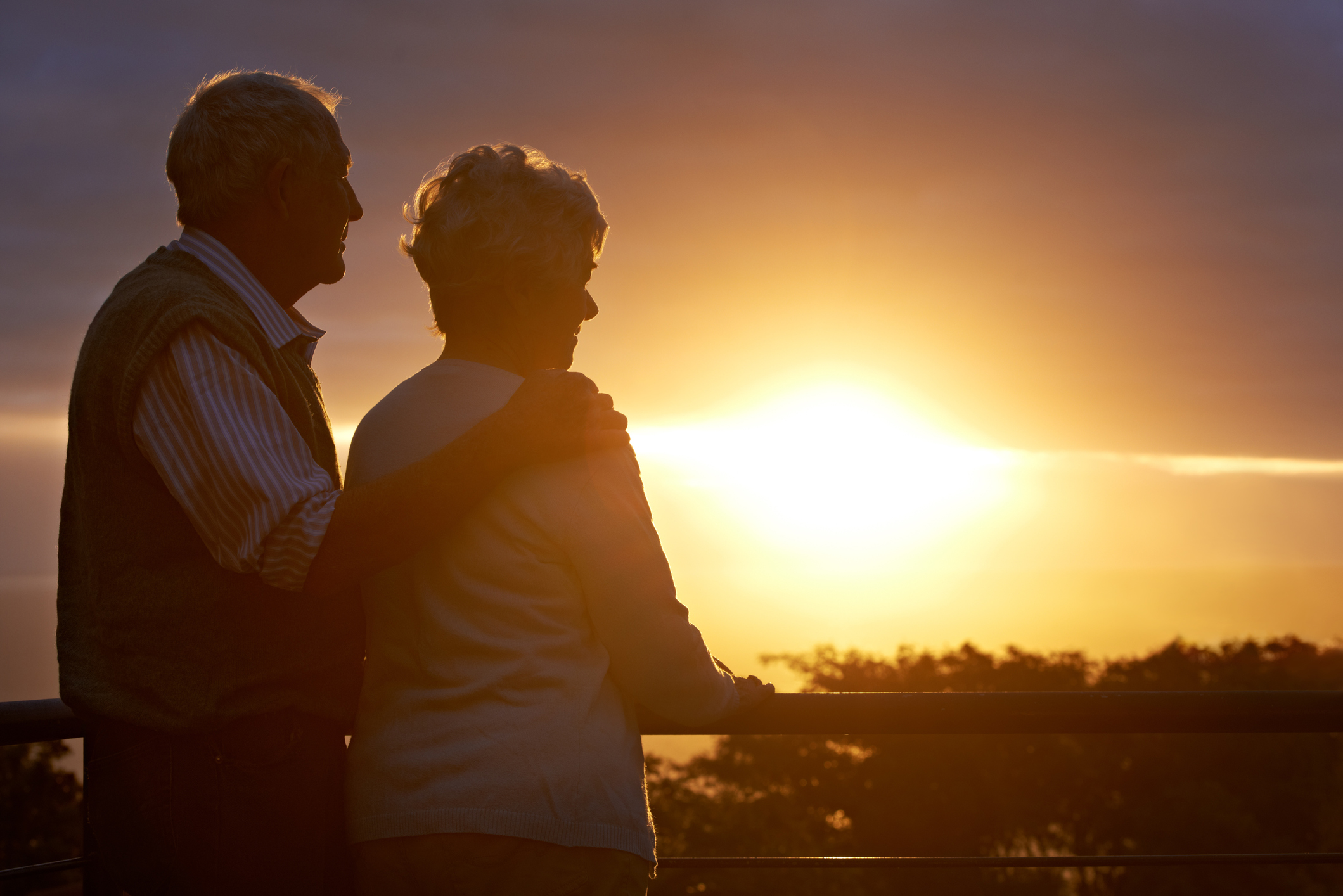 Two people watching the sun set.