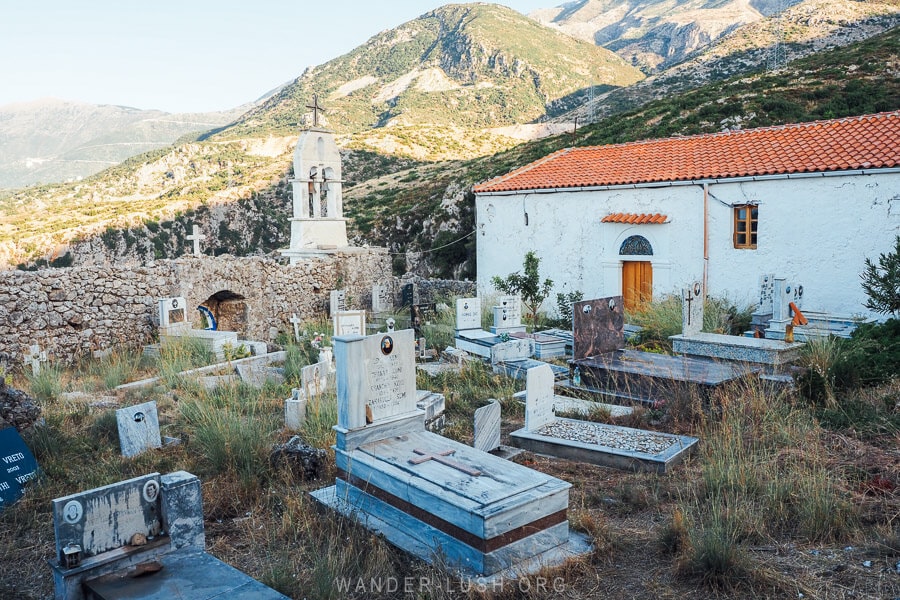 A small graveyard in front of a monastery overlooking the mountains in Dhermi.