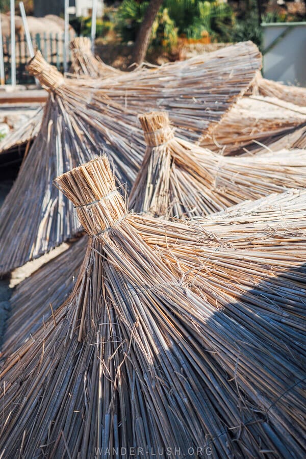 A cluster of thatched umbrellas on a quiet beach in Albania.