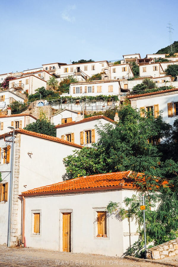 White houses with wooden shutters in Vuno, a charming village on the Albanian coast.