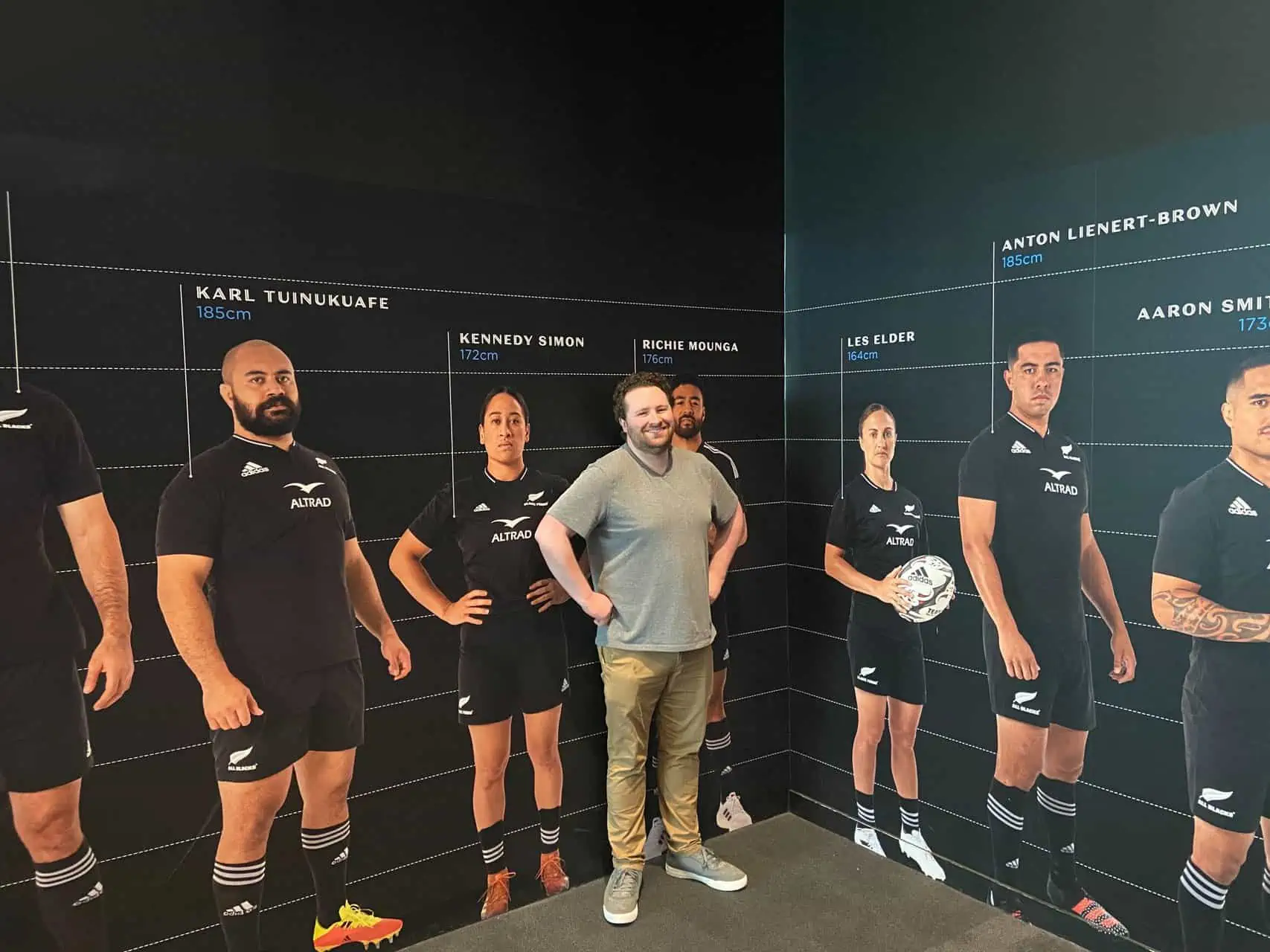 Colin posing with the All Blacks at the All Blacks Experience in Auckland