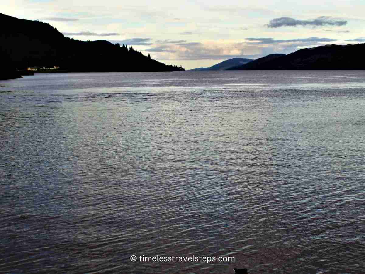 view of Loch as the sun slowly sets beyond the horizon