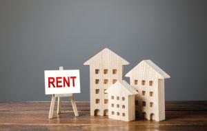 Three figures of houses and an easel with the word rent