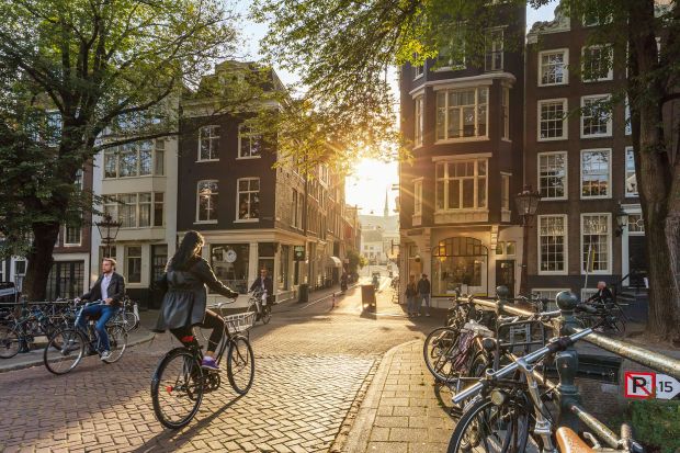 The Netherlands is among the happiest countries on the planet, according to pollsters Gallup. Bicyclists are sure to be at home in Amsterdam (above) and other cities in the Netherlands.(a_Taiga/iStock Editorial/Getty Images)