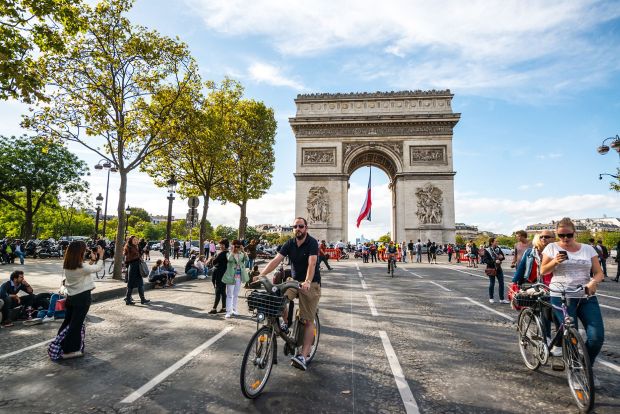 France offers residents numerous social benefits along with memorable opportunities such as cycling down the Champs-Elysees in Paris on car-free days.(anouchka/iStock Unreleased/Getty Images)