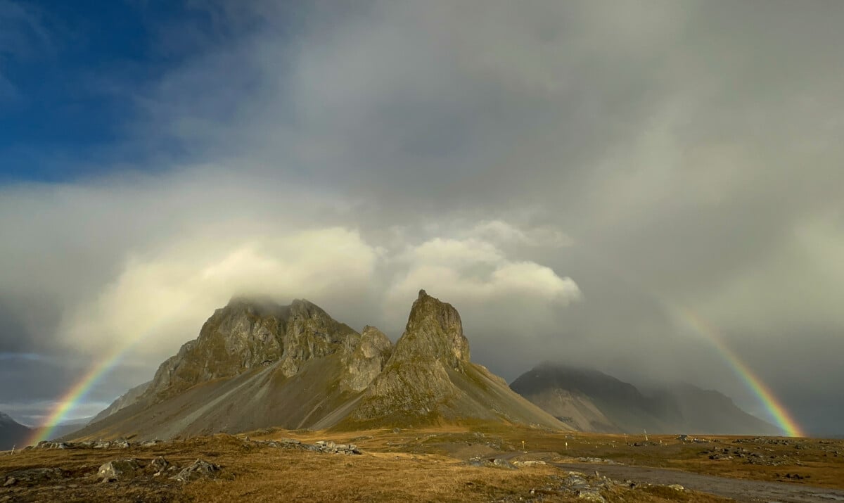 full rainbow over mountains in iceland