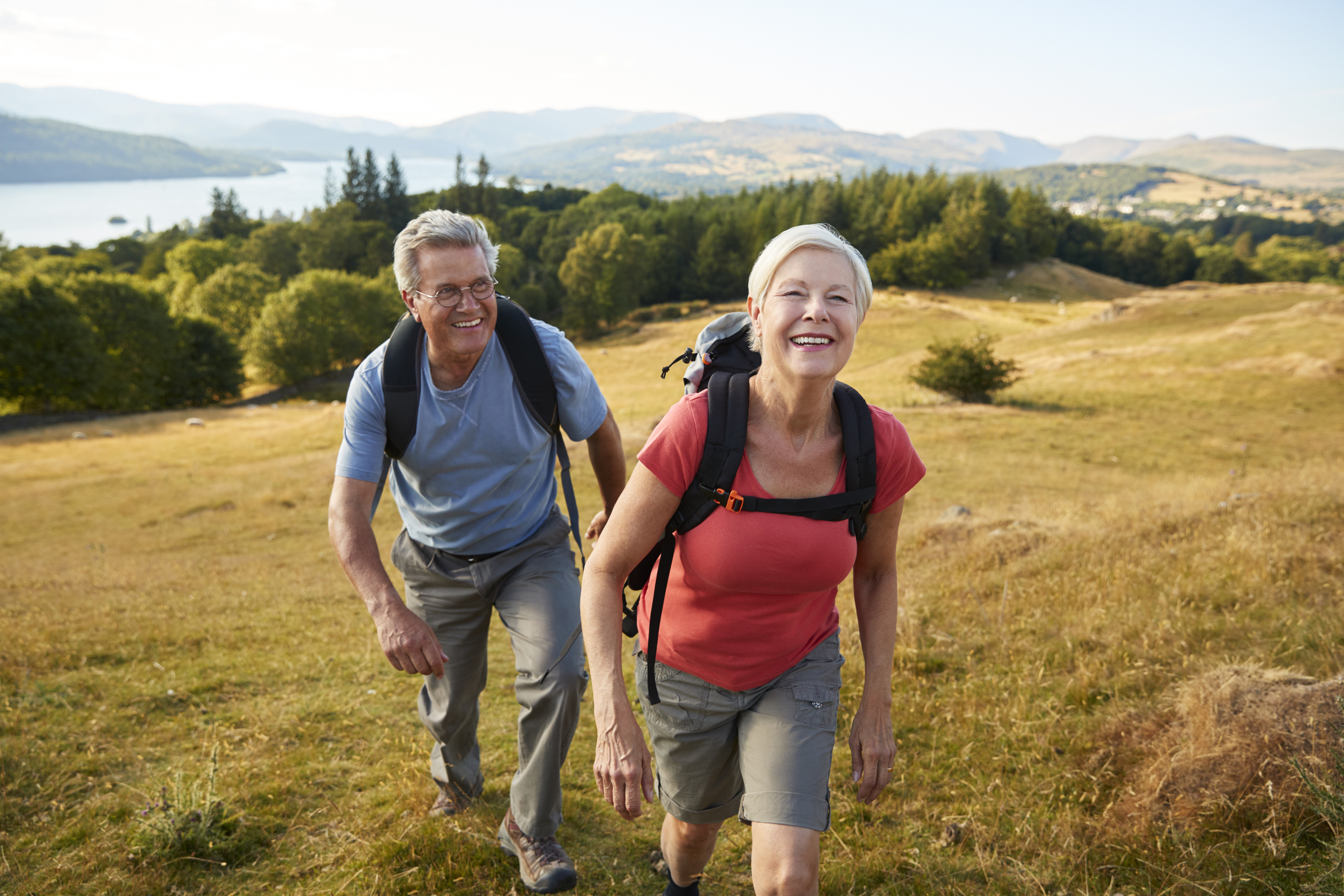 Smiling couple hiking outdoors.