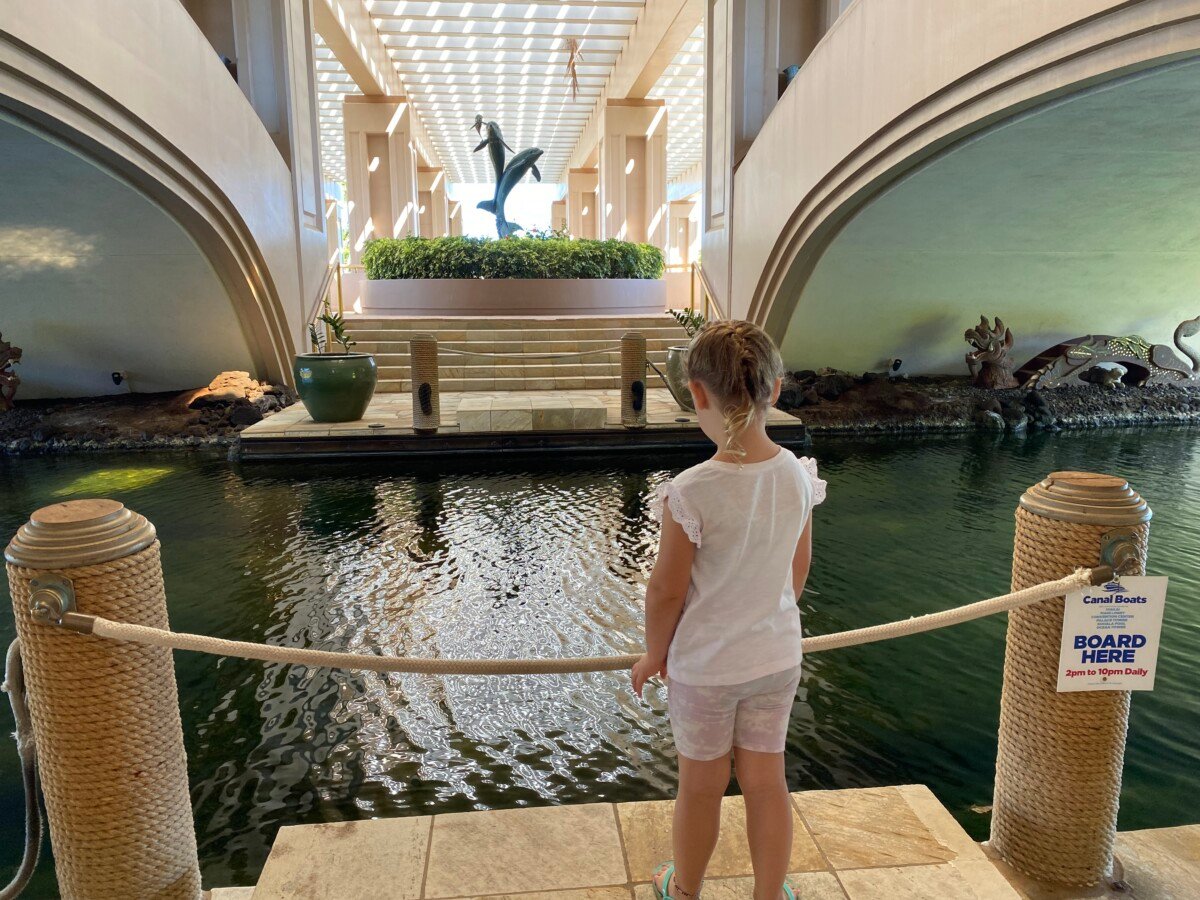 Little girl standing in front of the canal at the Ocean Tower entryway 