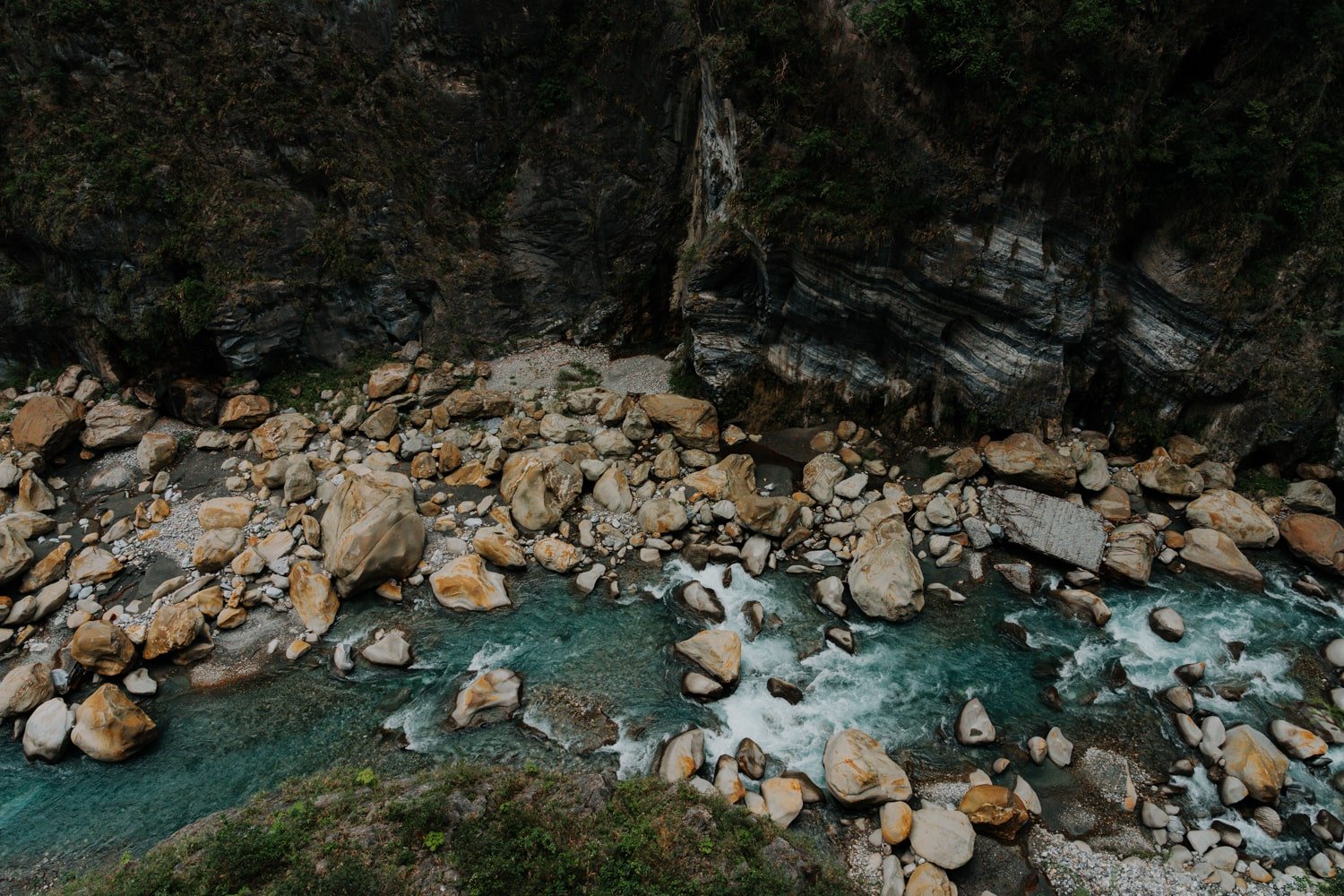 Looking down on the blue Liwu River inside Taroko Gorge with marbled canyon walls.