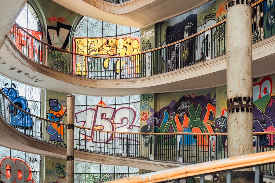 Inside an abandoned cable car station in Tbilisi, with a corkscrew staircase and graffiti art on the walls.