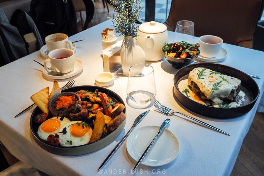 A breakfast table set for two in Tbilisi, with a full English breakfast and eggs.